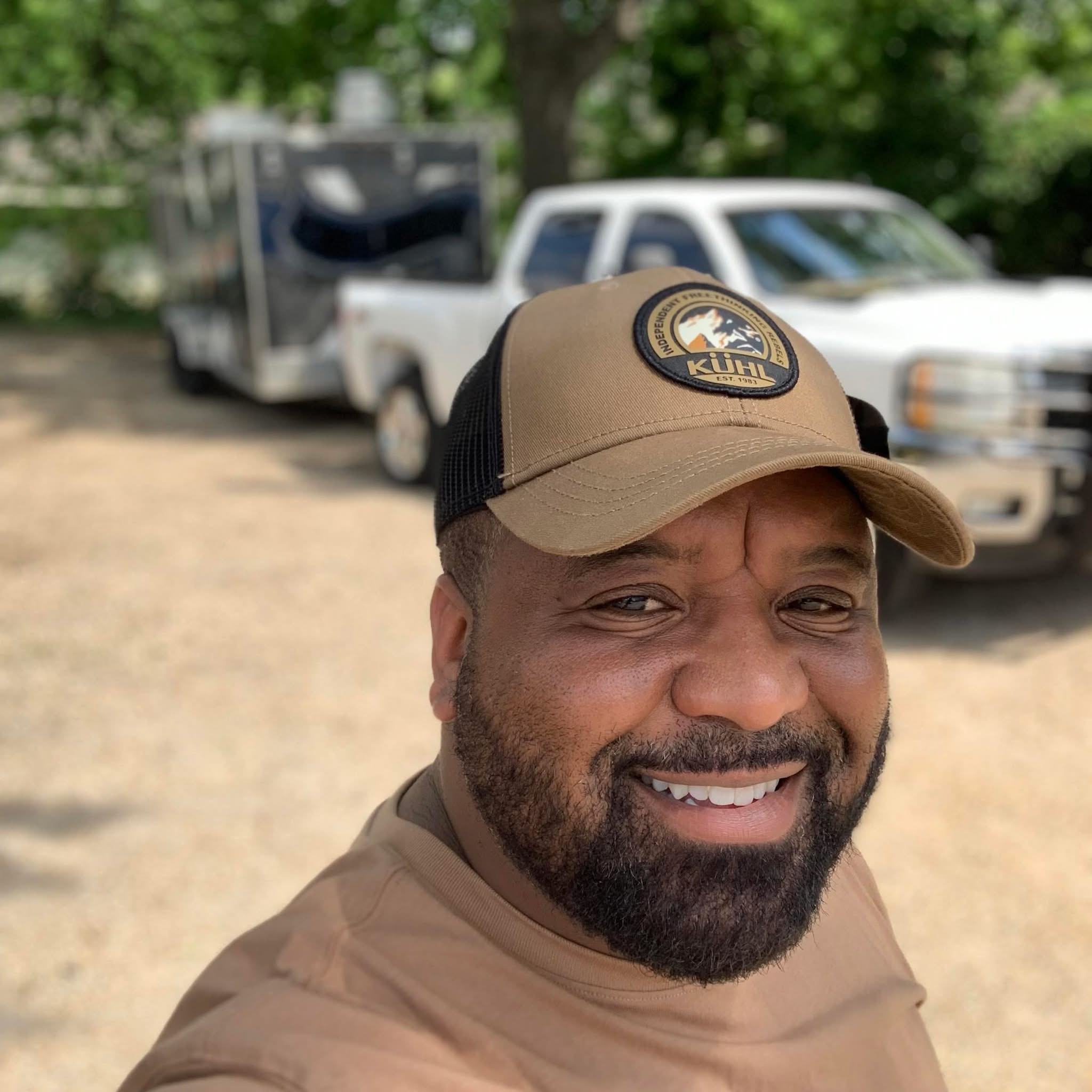 Earnie of Earnie’s Food Truck smiling outside the trailer